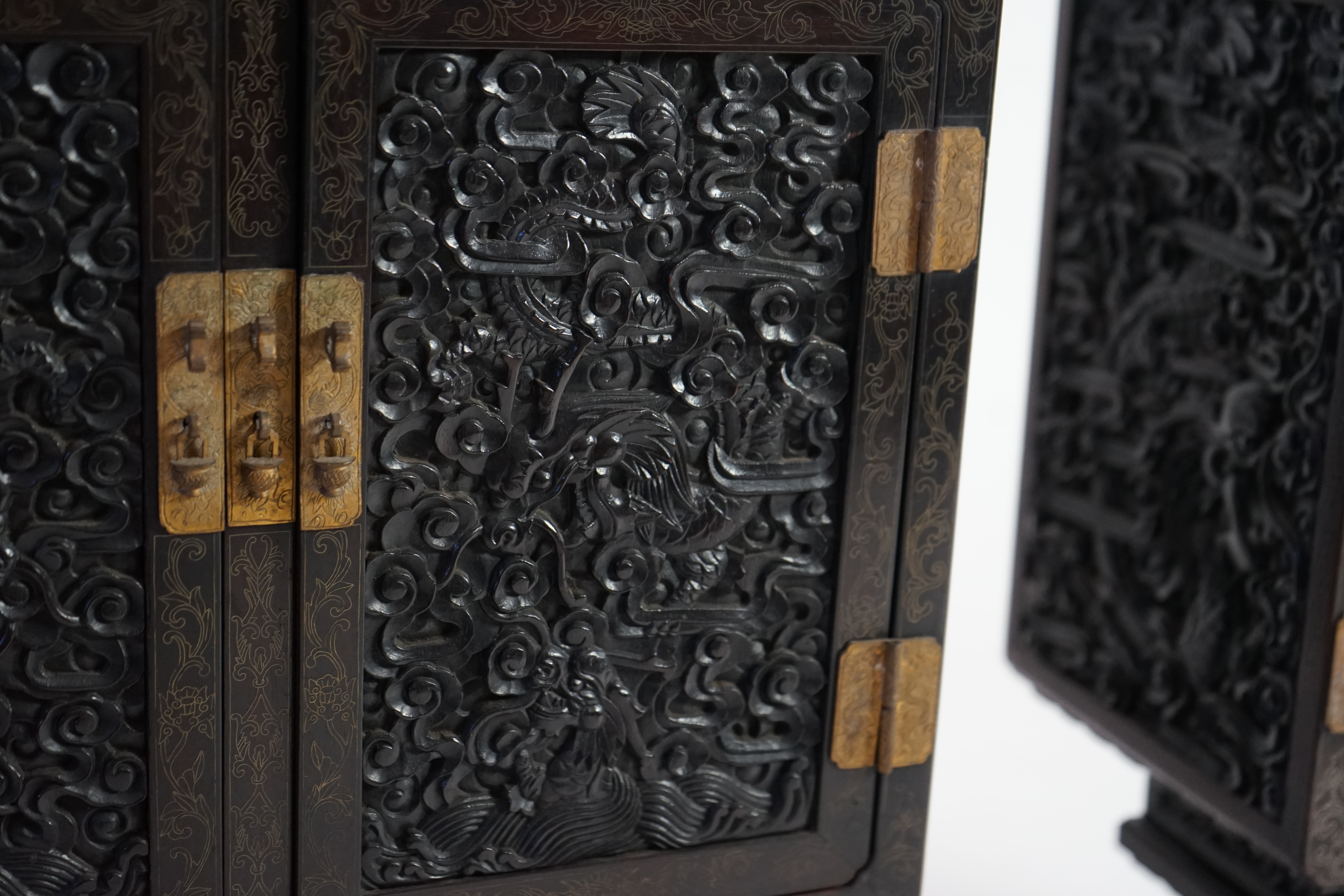 An important pair of Chinese carved zitan and silver wire inlaid ‘cloud and dragon’ curio cabinets and stands, duobaoge, probably Imperial, late Qing dynasty